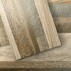 wood planks are stacked on top of each other in different colors and sizes,