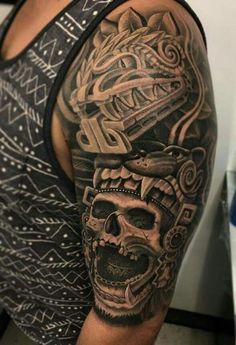 a man's arm with a tattoo on it and a skull in the middle