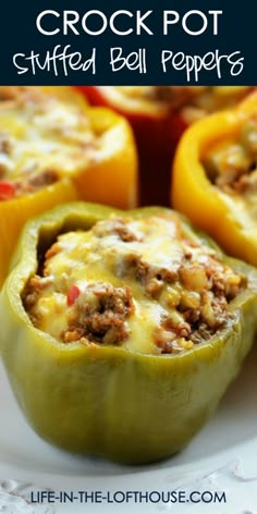 stuffed bell peppers on a white plate with the words crock pot stuffed bell peppers