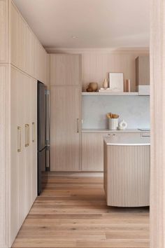 a kitchen with wooden floors and cabinets