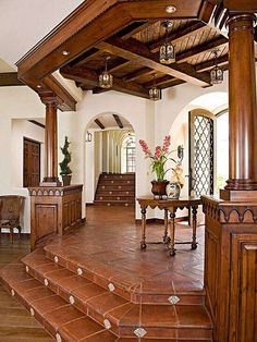 a living room filled with furniture and wooden stairs