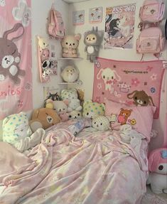 a child's bedroom with stuffed animals on the wall and pink bed linens