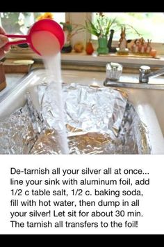 a person pouring water into a metal pan with foil on the bottom and red spoon in it