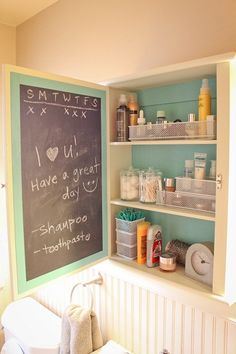 a chalk board in the corner of a bathroom