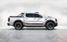 a white pick up truck parked on top of a cement floor