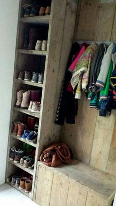 a wooden bench sitting in front of a closet filled with shoes