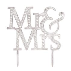 a cake topper with the word mr and mrs on it's side, surrounded by diamonds