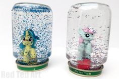 two glass vases with different types of glitter in them, one is blue and the other is yellow