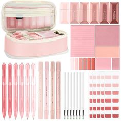 the contents of a pink makeup set including pens and pencils