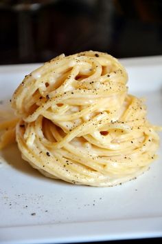 a white plate topped with spaghetti and sauce