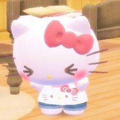 the hello kitty character is standing in front of a wooden fence and looking at something