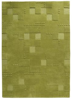 a green rug with squares and rectangles on it