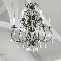 a chandelier hanging from the ceiling in a room with white walls and ceilings