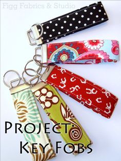 four key fobs with different designs on them and the words project key fobs