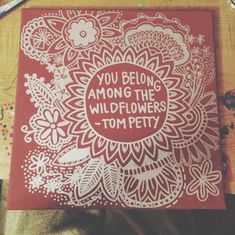 a card that says you belong among the wildflowers tom pettig on it