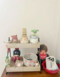 there is a shelf that has some toys on it and other items in the background