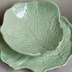 two green dishes sitting on top of each other