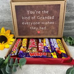 a box filled with chocolates next to a sunflower and a sign that says you're the kind of grandad everyone wishes they had