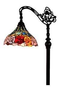 a lamp that is sitting on top of a pole with a flowered glass shade