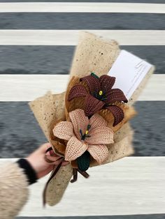 a person holding a bouquet of flowers in their hand