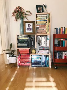 a bookshelf filled with lots of books on top of a hard wood floor