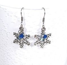 These cute snowflake earrings have blue bicone dangles to add a touch of winteriness to the snowflakes and have hypoallergenic ear wires. An extra pair of earring backs/nuts are included. Earrings Bead, Snowflake Earrings, Silver Bells, Wide Bracelet, Winter Snowflakes, Memory Wire Bracelets, Themed Jewelry, Wire Bracelet, Memory Wire