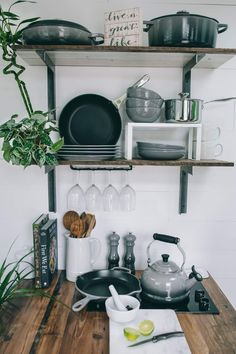 pots and pans are sitting on the shelf above the stove