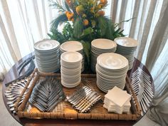 a tray with plates and silverware on it