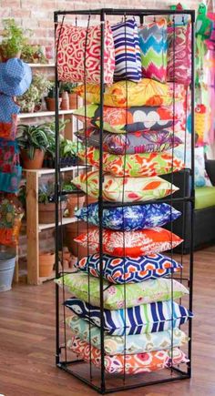 a rack filled with lots of colorful pillows