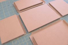 four pieces of cardboard sitting on top of a cutting board