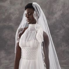 a woman in a white wedding dress and veil