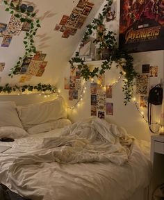 an unmade bed in a dorm room with plants growing on the wall above it