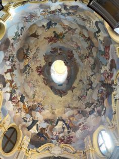 an ornate ceiling with many paintings on the ceiling and windows above it, in a church