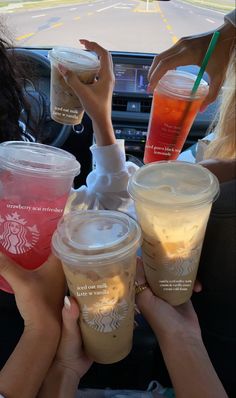 starbucks drinks are being served in the back seat of a car