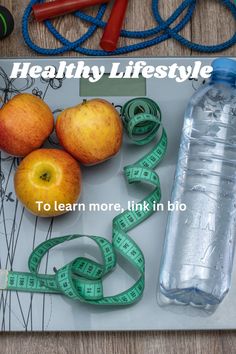 an apple, water bottle and measuring tape on a cutting board with the words healthy lifestyle to learn more, link in bio