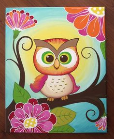 an owl is sitting on a tree branch with pink flowers and leaves in the background