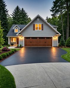 a large house with two garages in the front yard and landscaping around it at night