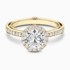 a rose gold engagement ring with an oval diamond center and pave set diamonds around the band