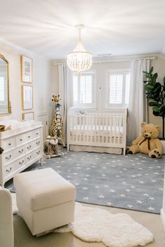 a baby's room with white furniture and decor