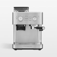 an espresso machine sitting on top of a white table