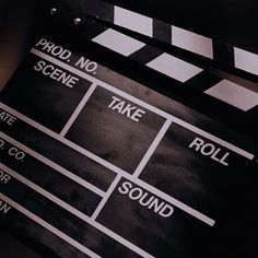 a black and white photo of a movie clapper