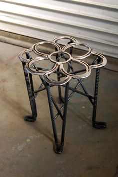 four metal rings are stacked on top of each other in the middle of a room