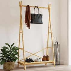 Clean up your closet and easily pick out your outfit with this clothes rack! Durable and long-lasting: As a natural material, bamboo boasts good breathability and a low odor. These qualities make the clothes rack durable, water-resistant, and long-lasting. Ample storage space: The coat rack with shelf has plenty of room for organizing your clothes and bags. The lower shelf is great for boxes and folded clothes or shoes. Stylish and compact design: The clean lines and minimalist design make the free standing coat rack blend into your room perfectly. The clothes stand is also perfect for small rooms due to its compact size. Warning: To prevent it from tipping over, this product must be used with the provided wall attachment device. Size: 40.2" x 19.7" x 74.8".  Age Group: adult. Bamboo Clothes Rack, Free Standing Coat Rack, Bamboo Clothes, Folded Clothes, Coat Rack Shelf, Shoes Stylish, Mini Clothes, Clothes Stand, Clothes Rail