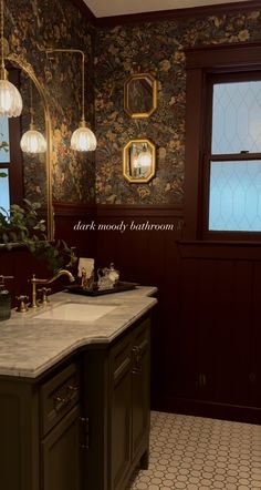 a bathroom with marble counter tops and dark wood paneling, along with wallpaper