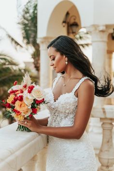 a woman in a wedding dress holding a bouquet