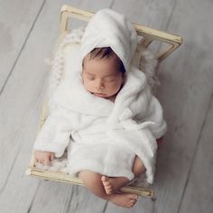 a newborn baby wrapped in a white blanket