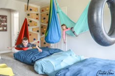 two children are playing in their bedroom with hammocks