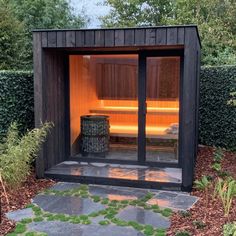 a small wooden sauna in the middle of a garden