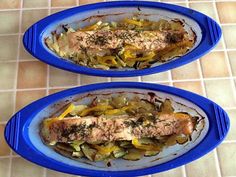 two blue plates filled with food on top of a tiled floor next to each other