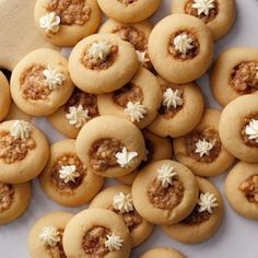 small cookies with white flowers are on a plate